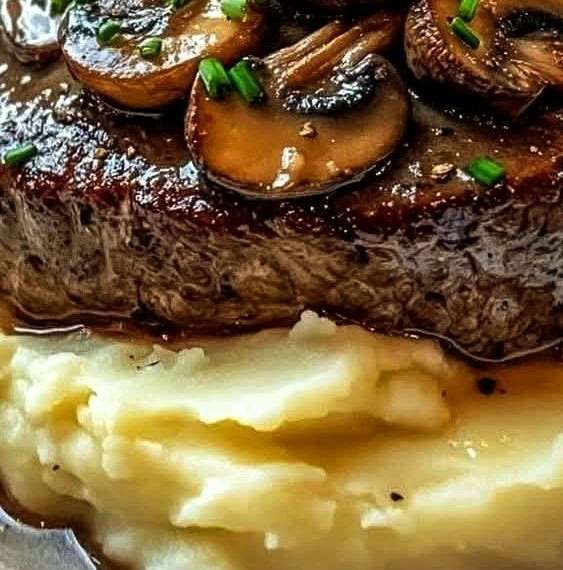 Steak with Mushroom Gravy on Creamy Mashed Potatoes